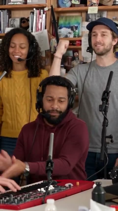 Keyboard player and two backing singers in the Outstanding Tiny Desk AI video finale reference