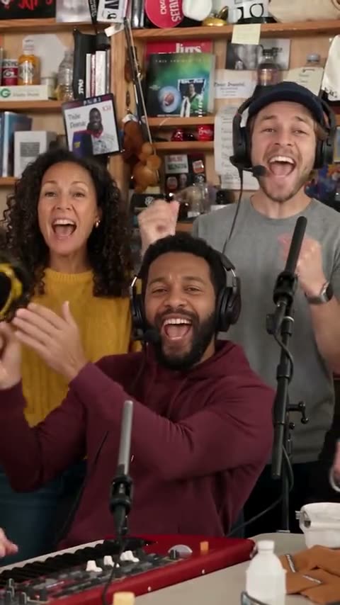 Keyboard player and backing singers in an Outstanding Tiny Desk concert reference