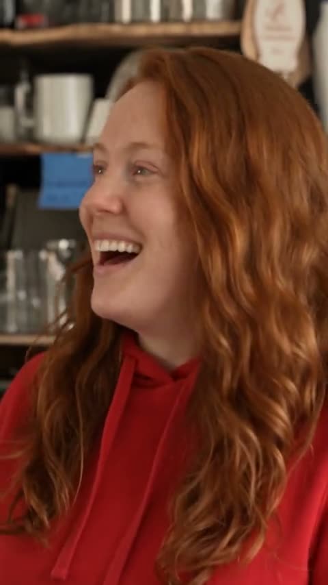 Woman laughing in an Outstanding AI meme concert reference scene